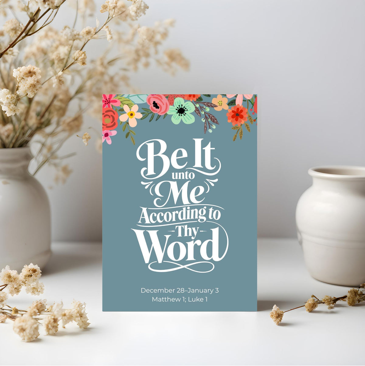 Teal blue New Testament scripture art poster reading Be It Unto Me According to Thy Word in white decorative typography
